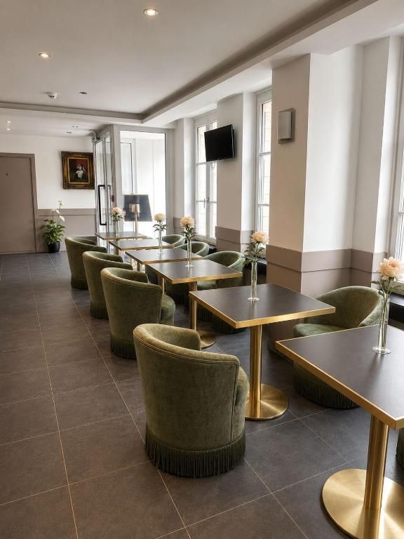 Salle de petit-déjeuner avec fauteuils verts